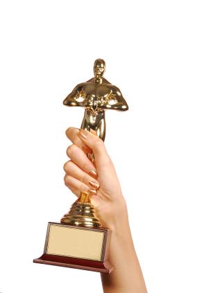 Hand holding academy award